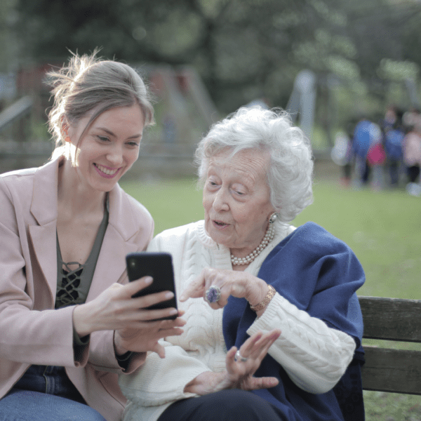 Grandaughter showing Grandmother photos on cell phone